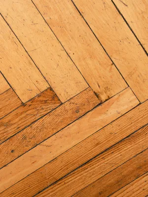 Close up of a warm oak floor laid in a herringbone pattern